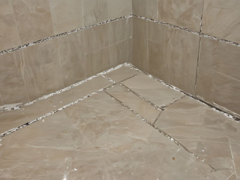 Elegant kitchen backsplash and flooring installation featuring ceramic subway tiles with contrasting grout